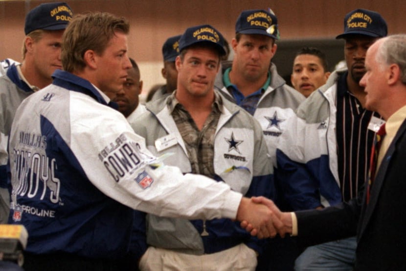 Dallas Cowboy  Troy Aikman, left shakes hands with Oklahoma Governor Frank  Keating,...