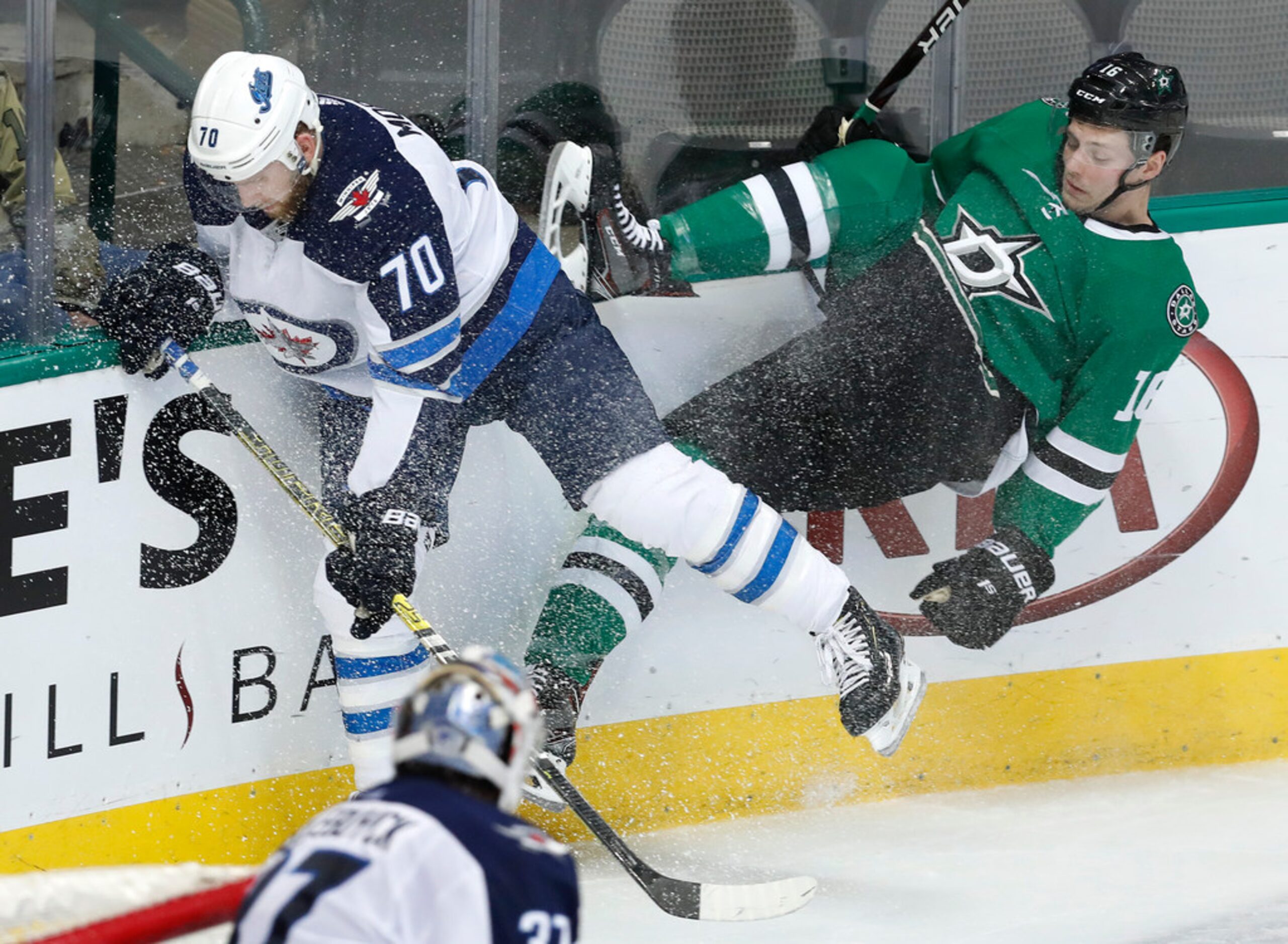 Winnipeg Jets defenseman Joe Morrow (70) and Dallas Stars center Jason Dickinson (16) hit...