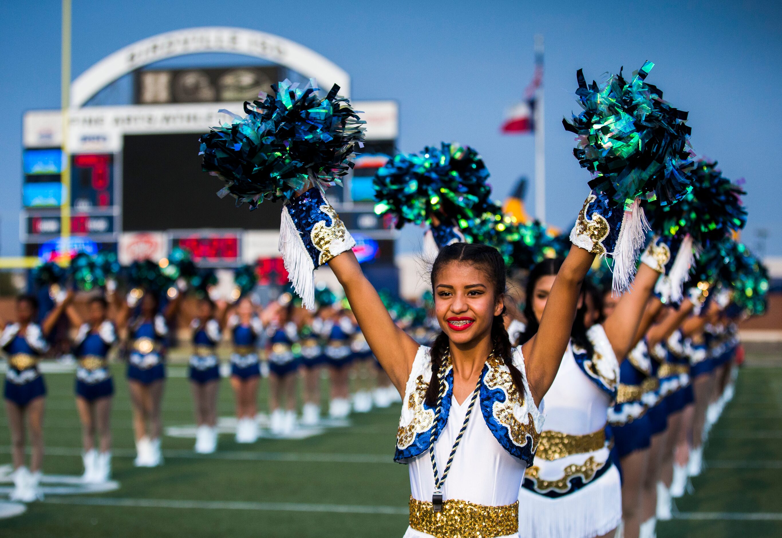 Arlington Lamar High School dance team member Itzel Gonzalez, 16, cheers with team mates...