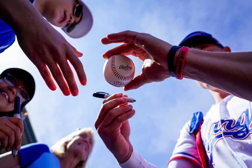 Rangers outfielder Scott Heineman signed autographs before an exhibition game against the...