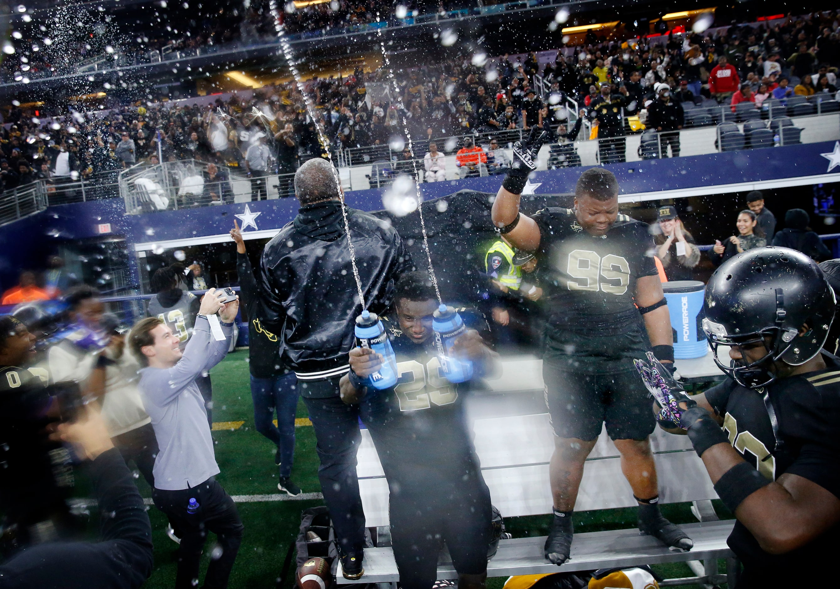 South Oak Cliff linebacker Jayden Shelton (29) sprays water bottles in the air and on head...