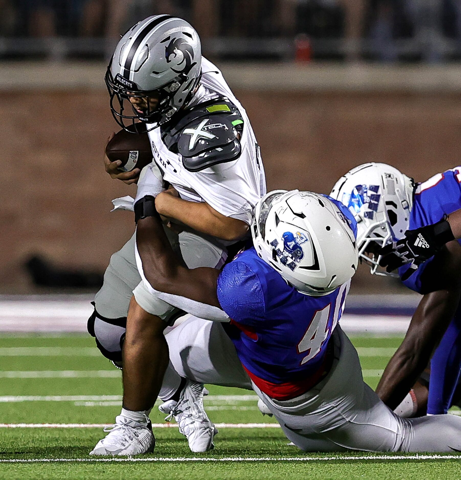 Denton Guyer quarterback Isaac Harney is sacked by Allen defensive lineman Nathan Marsh (40)...