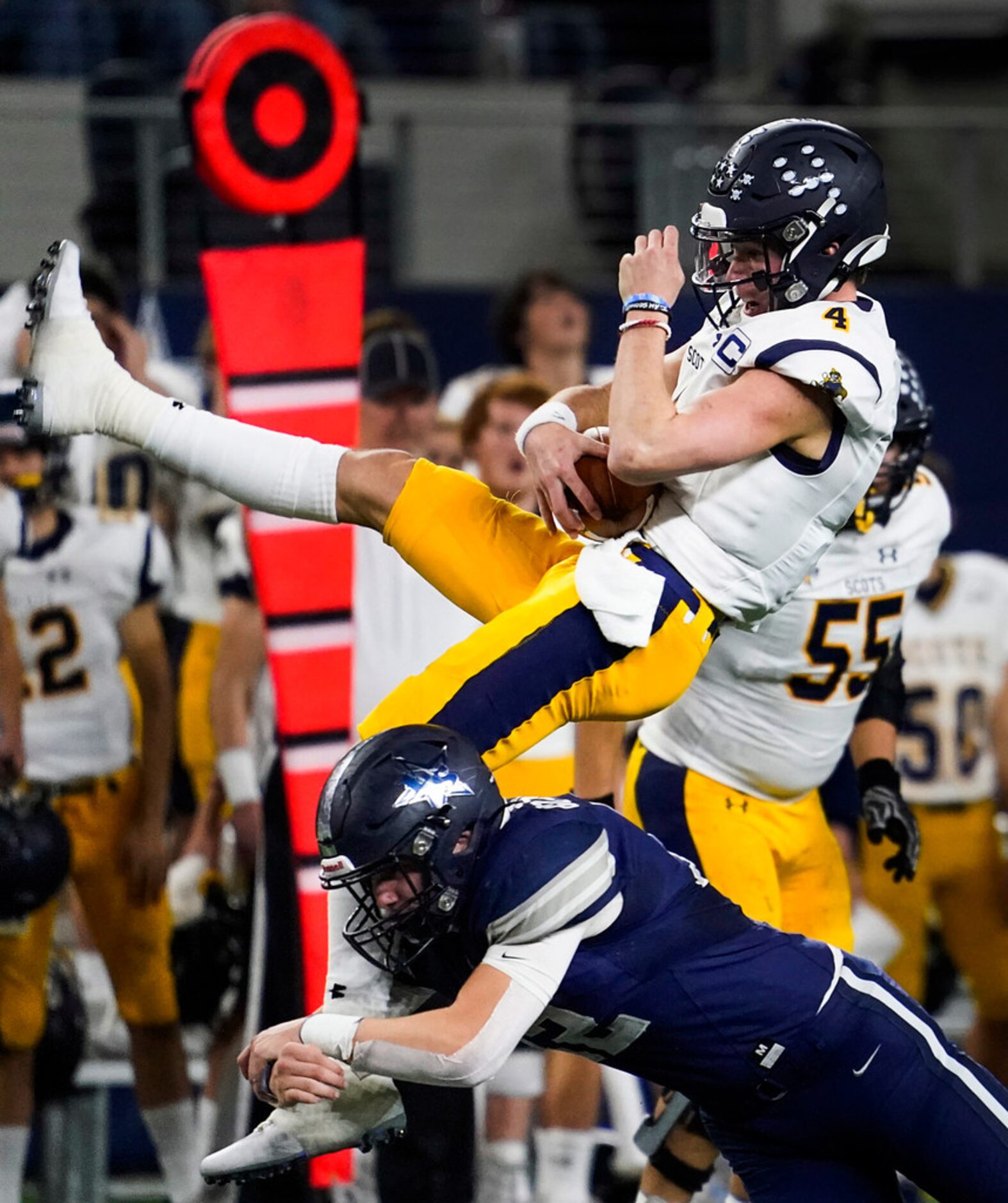 Highland Park quarterback Chandler Morris (4) is upended by Frisco Lone Star linebacker...