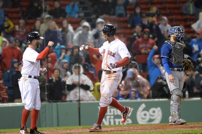 BOSTON, MA - MAY 25: Xander Bogaerts #2 of the Boston Red Sox slaps high fives after hitting...