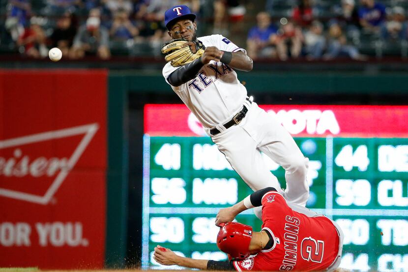 Texas Rangers second baseman Jurickson Profar (19) completes a double play after forcing out...