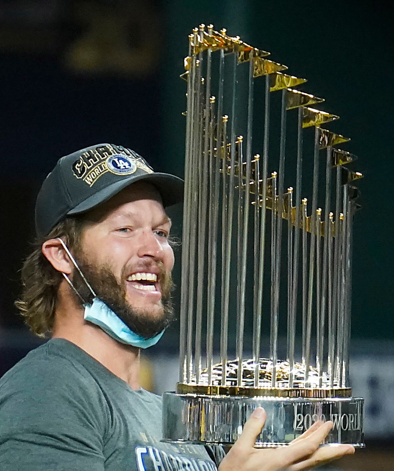 Los Angeles Dodgers starting pitcher Clayton Kershaw celebrates with the championship trophy...