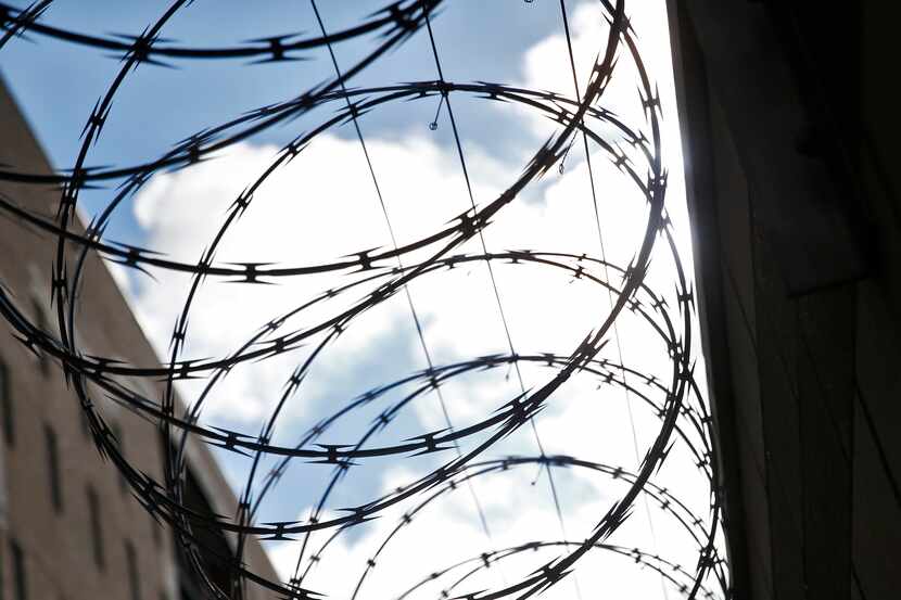 Barbed wire on the fence of Kays Tower Jail in Dallas on June 28, 2017.  (Nathan...