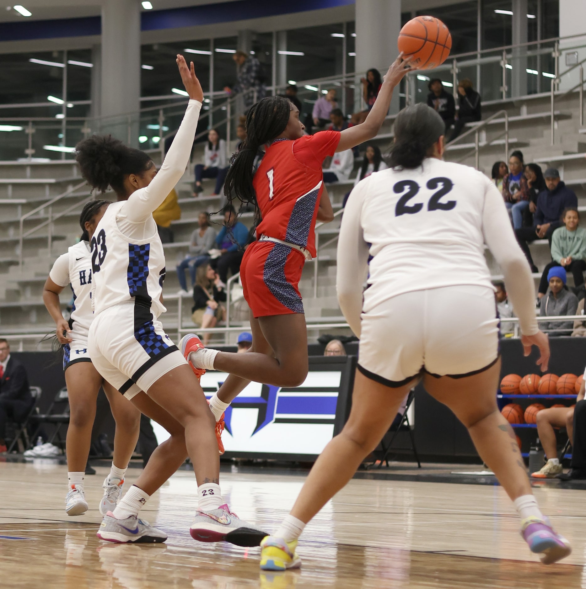 Denton Ryan guard Dashia Johnson (1), center, gets off a jump pass between Hebron defenders...