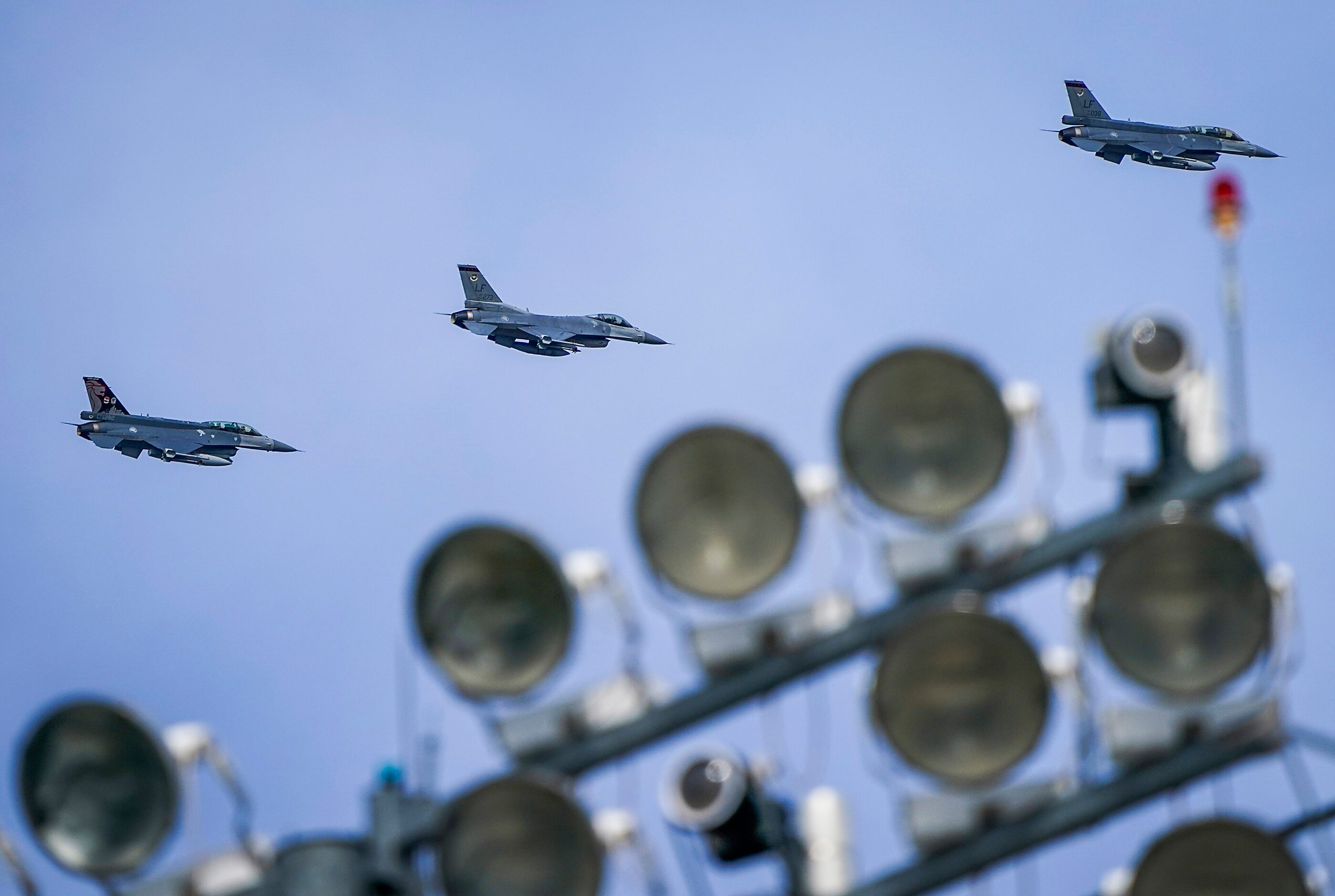 Air Force jets fly over the stadium during the sixth inning of a spring training game...