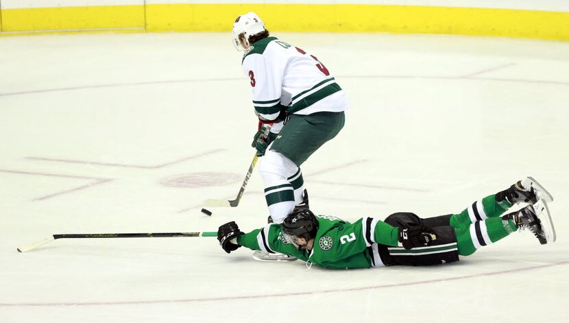 Dallas Stars defenseman Kris Russell (2) tries to make a divng stop at Minnesota Wild center...