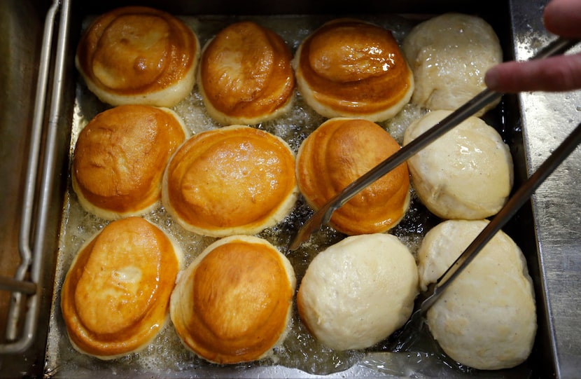 Pastry chef Justin Biggs flips doughnuts in the fryer at Back Dough.