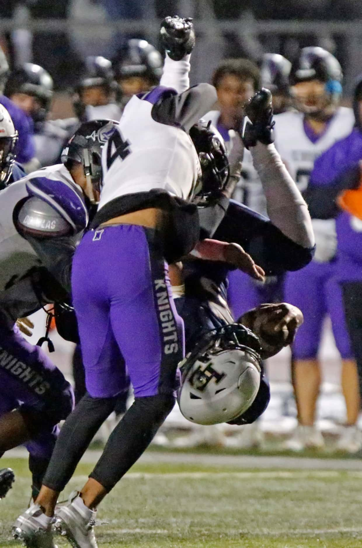 Little Elm High School running back Jason Jackson (5) is upended by Independence High School...