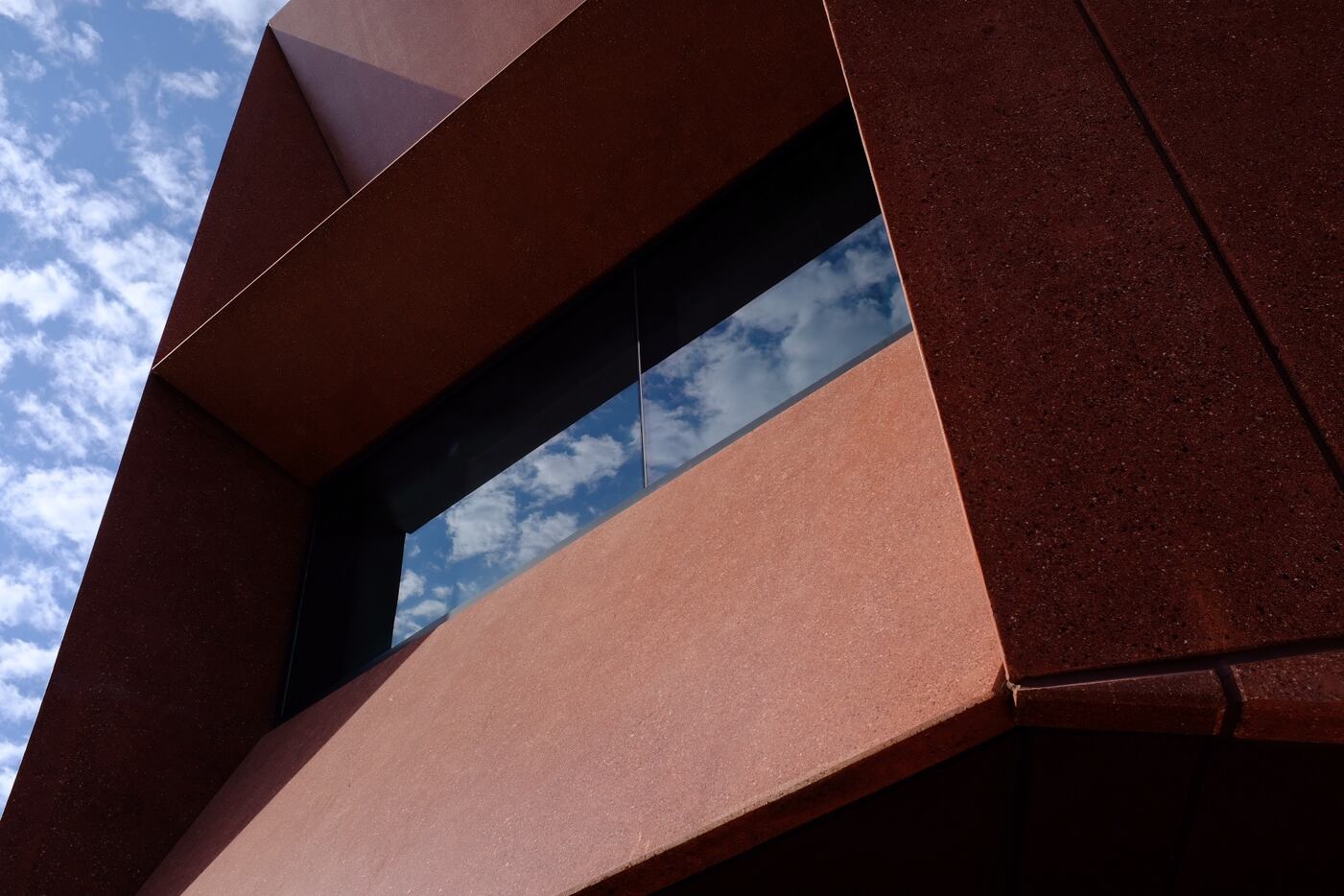 Shadows and reflections on the chiseled concrete block of Ruby City, David Adjaye, architect.
