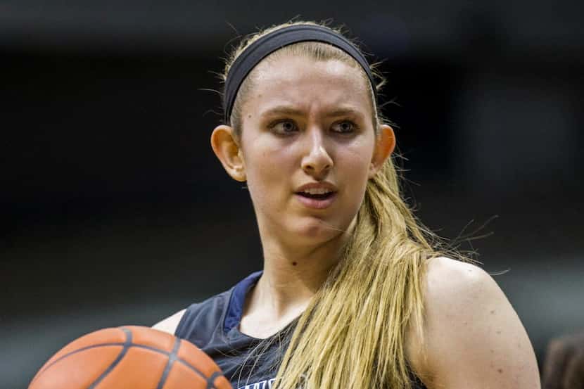 Flower Mound center Lauren Cox (44) hands off the ball at a time out during their UIL Class...