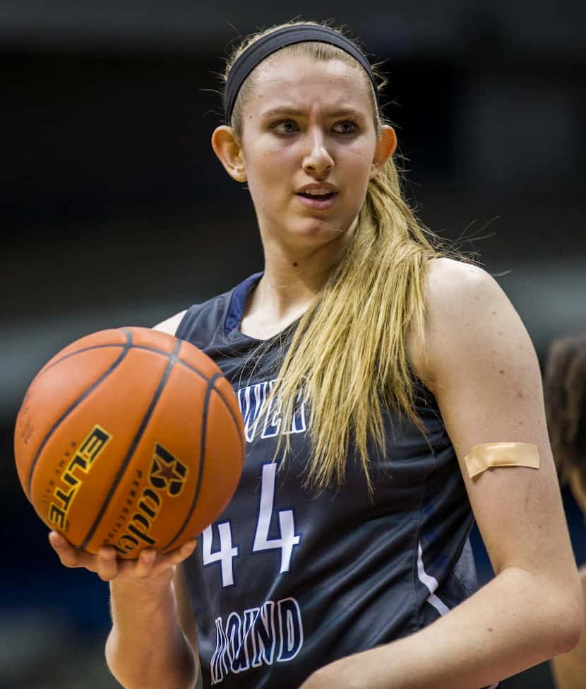 Flower Mound center Lauren Cox (44) hands off the ball at a time out during their UIL Class...
