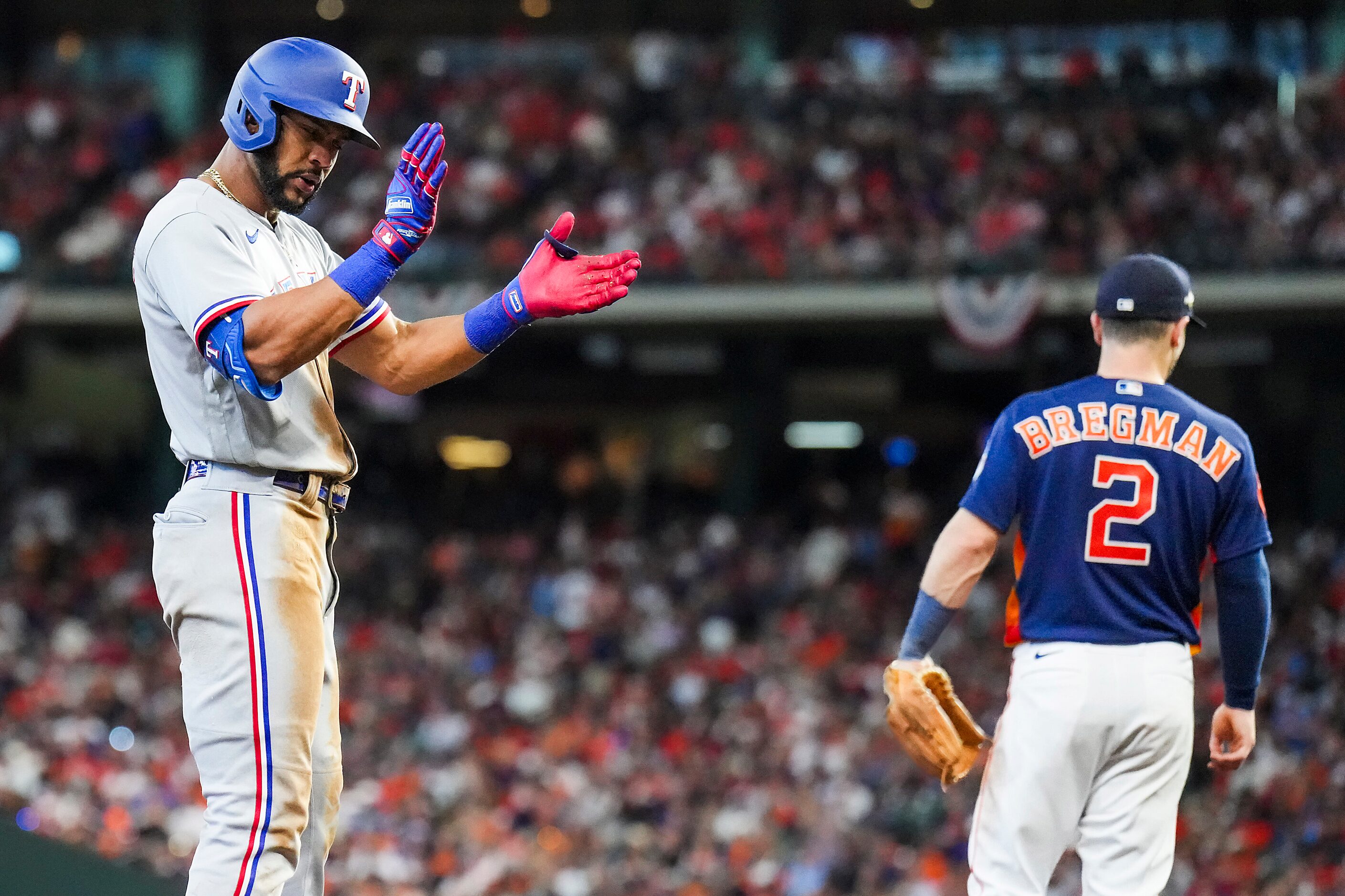 Texas Rangers center fielder Leody Taveras celebrates after reaching third base with a...