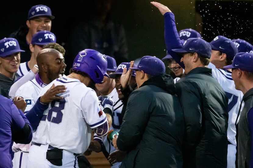 TCU Gray Rodgers (28) is congratulated by teammates after hitting a two-run home run during...