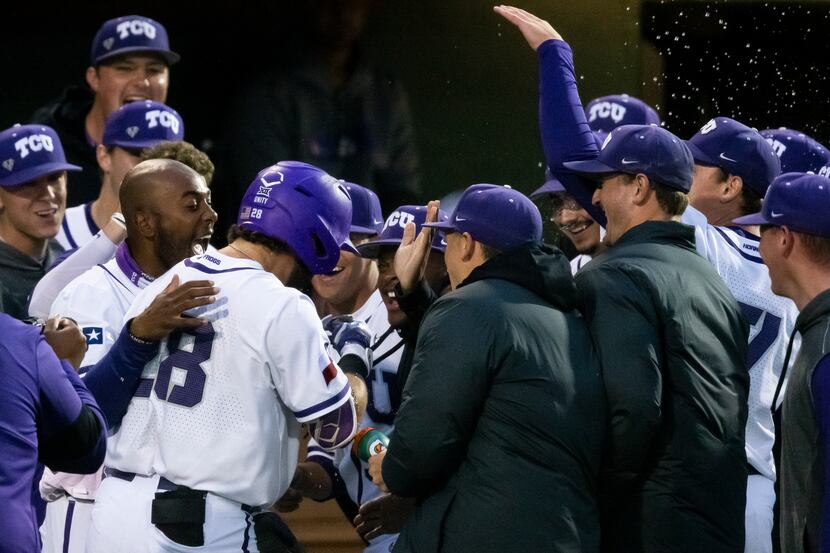 TCU Gray Rodgers (28) is congratulated by teammates after hitting a two-run home run during...