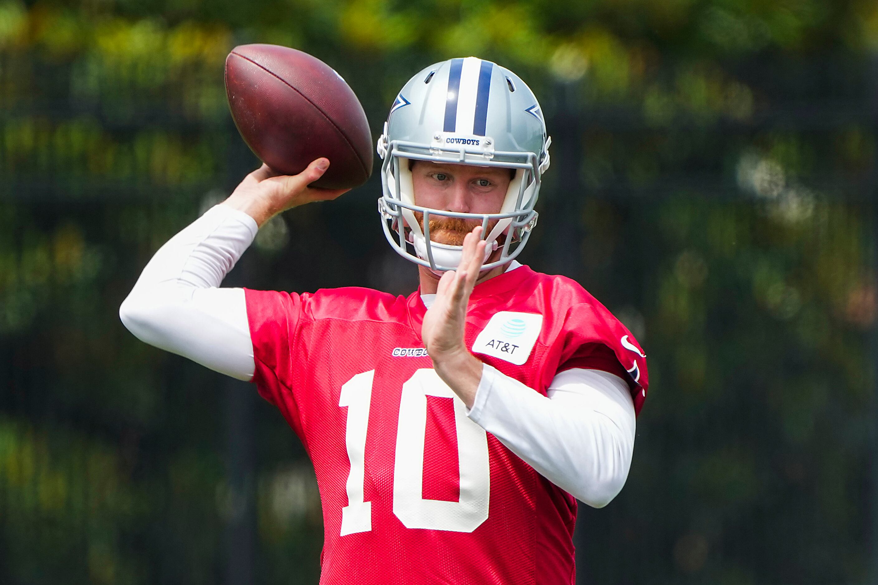 Dallas Cowboys quarterback Cooper Rush throws a pass during a minicamp practice at The Star...