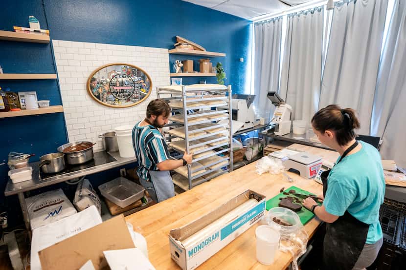 Tom Cedeño, left, moves dough to the freezer while sous chef Jessica Shaw cuts chocolate at...