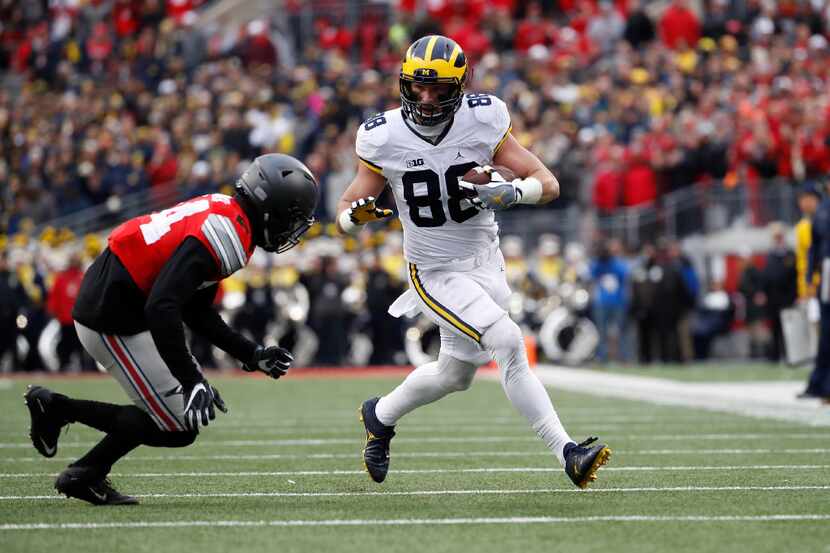 COLUMBUS, OH - NOVEMBER 26:   Jake Butt #88 of the Michigan Wolverines runs after catching a...