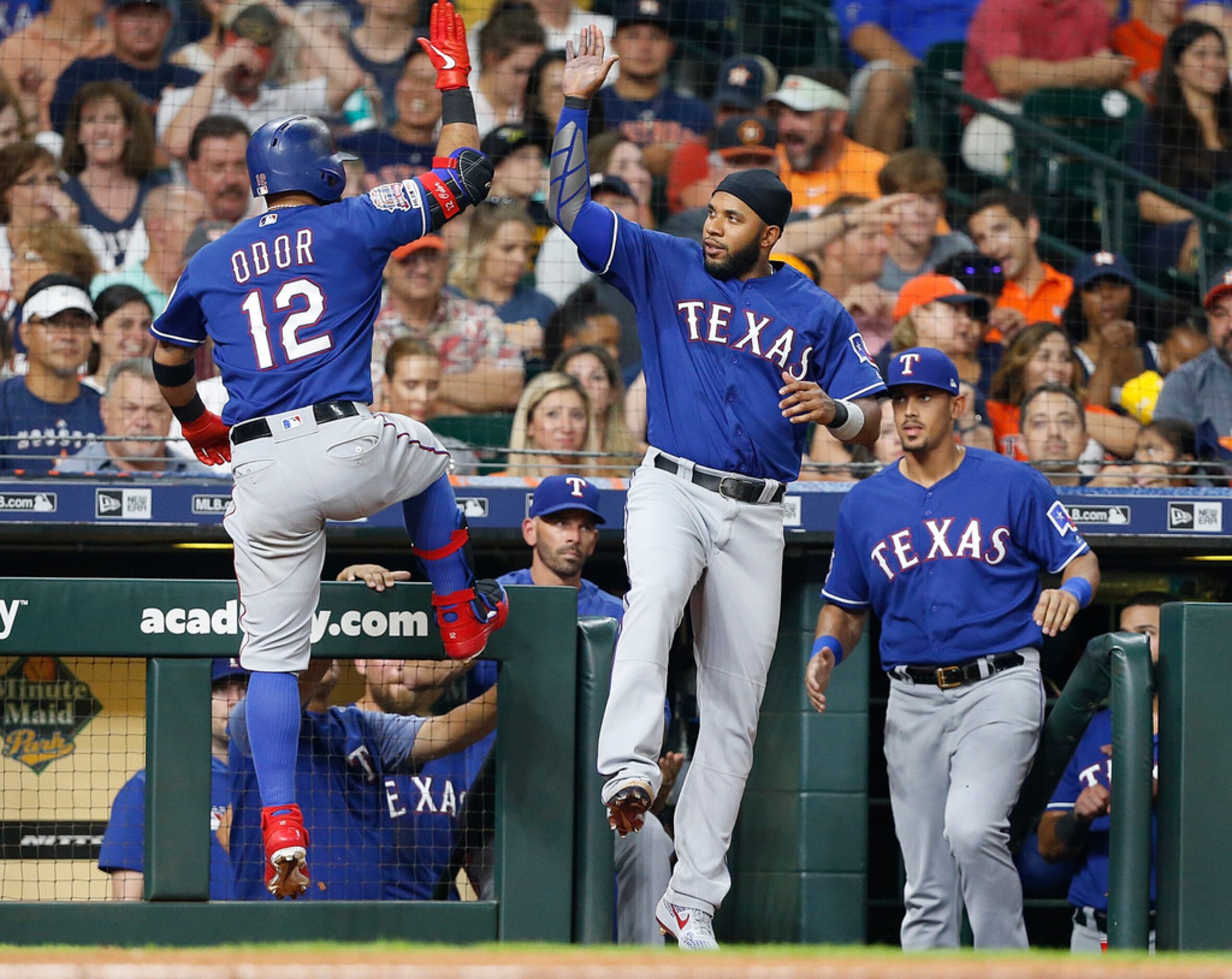 HOUSTON, TEXAS - JULY 19: Rougned Odor #12 of the Texas Rangers receives a high five from...