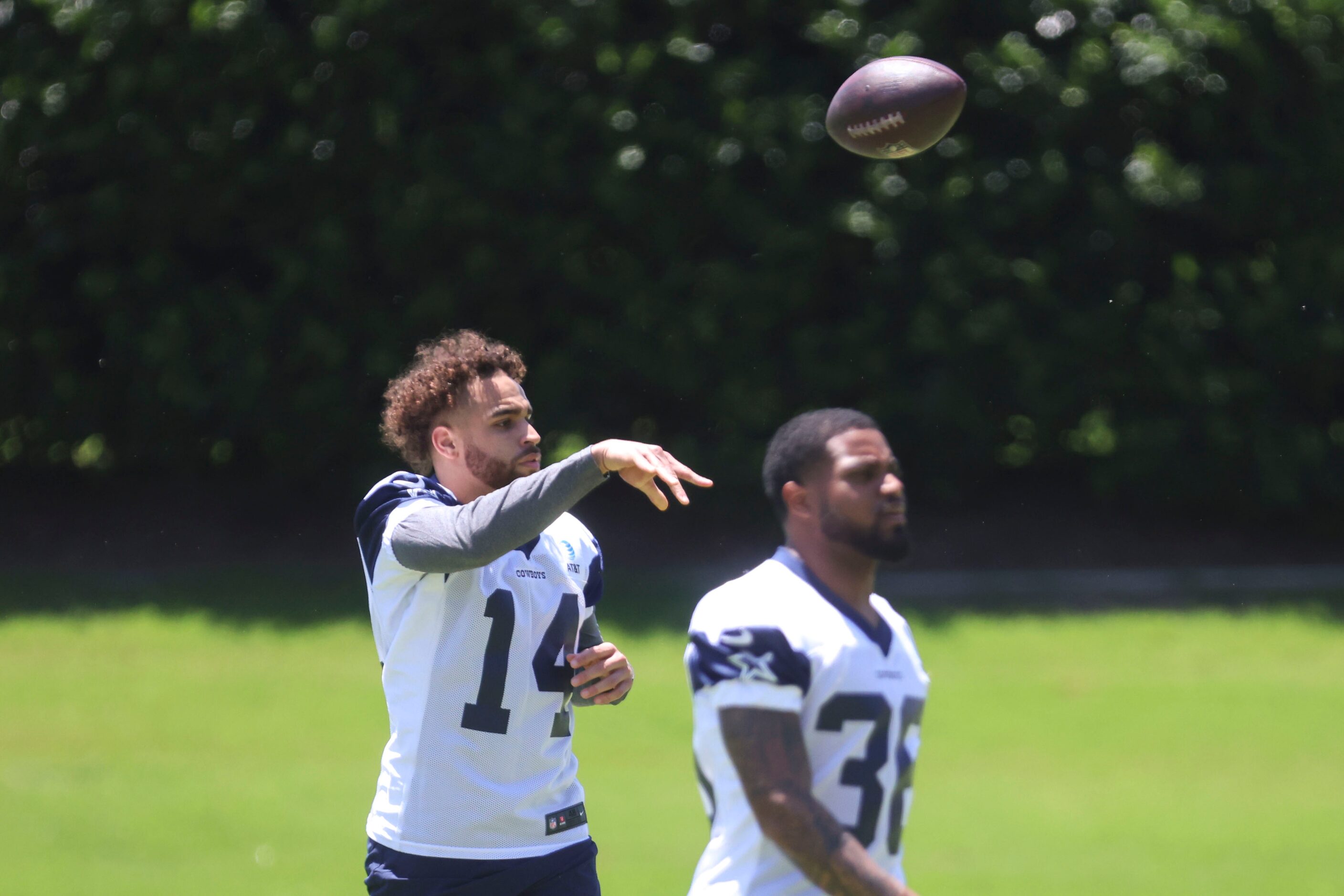 Dallas Cowboys wide receiver Cam Johnson (14) throws the ball during a rookie minicamp, on...