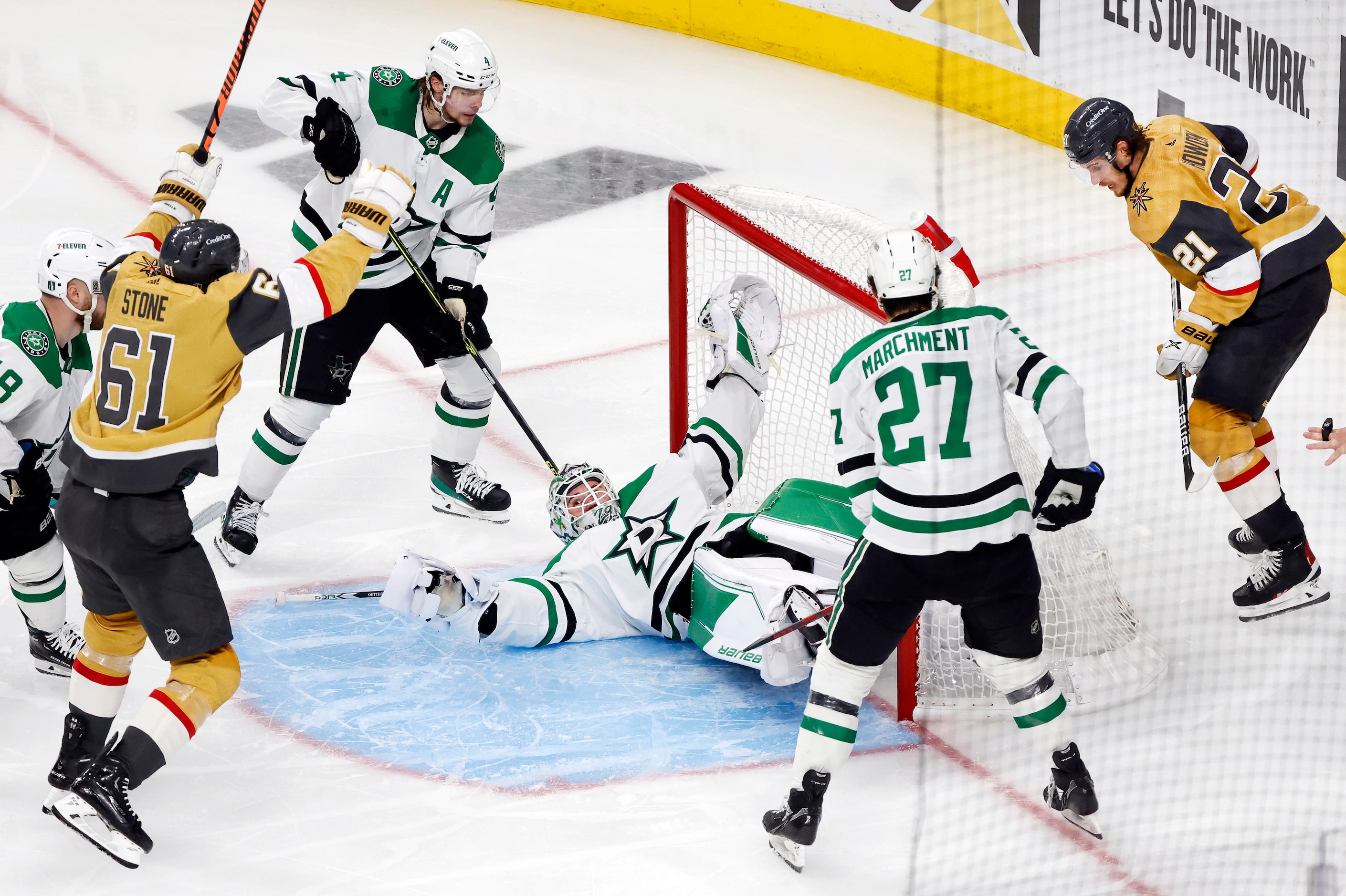 Dallas Stars goaltender Jake Oettinger (29) fans on his back as he’s scored on by Vegas...