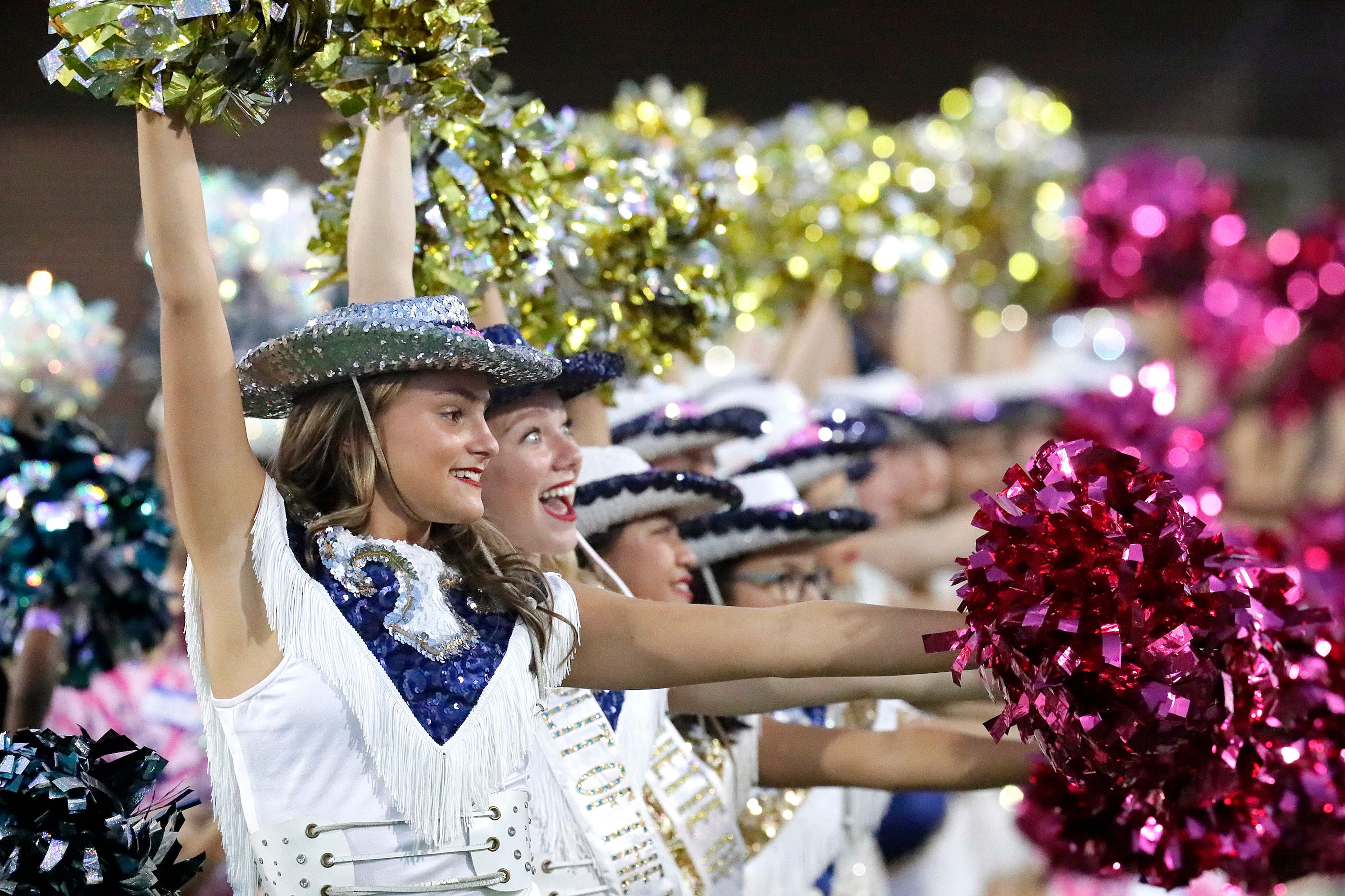 Shelby Biehumko, 17, with the McKinney High School Marquettes waits for the teams to take...