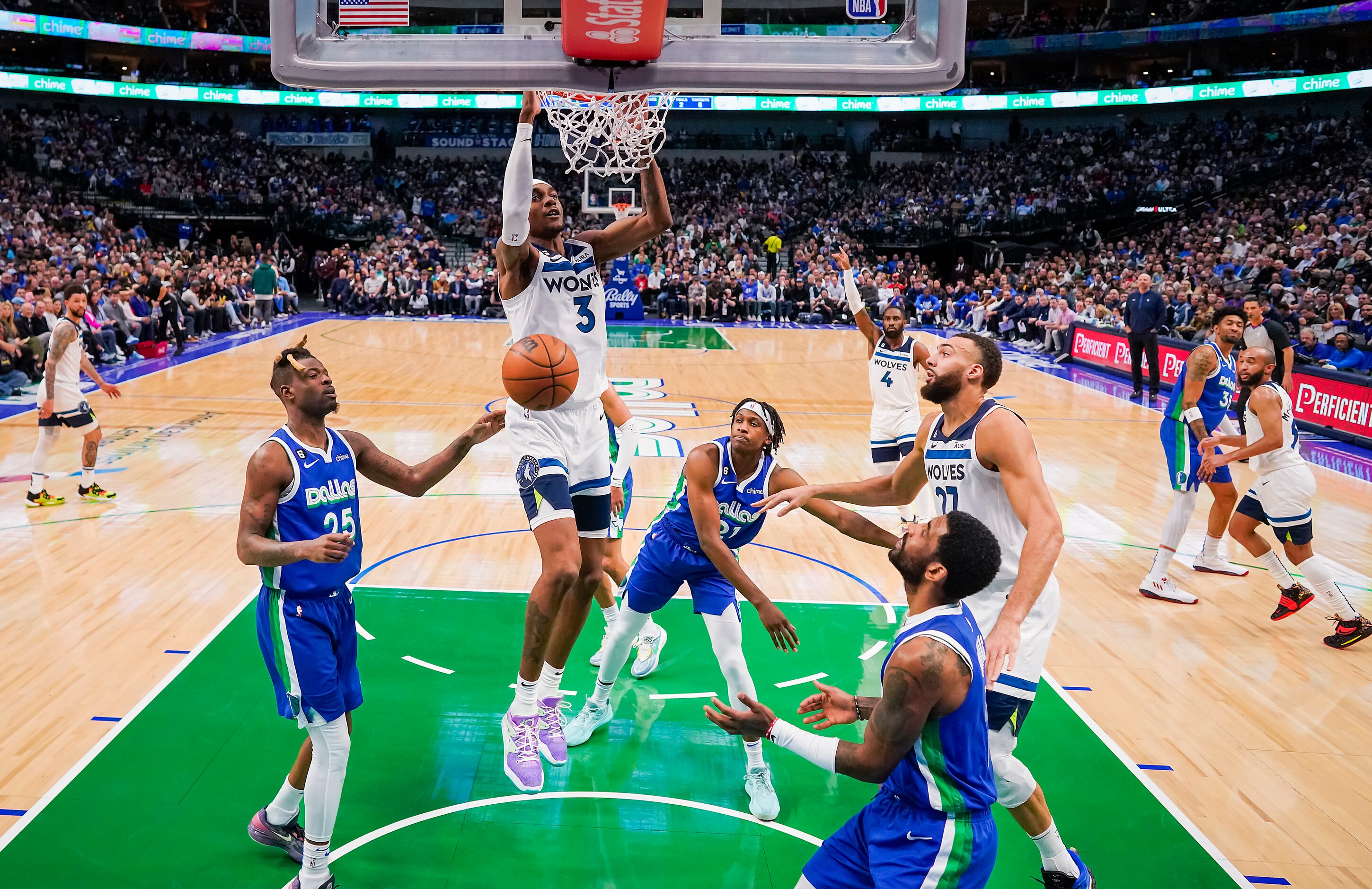 Minnesota Timberwolves forward Jaden McDaniels (3) dunks the ball past Dallas Mavericks...