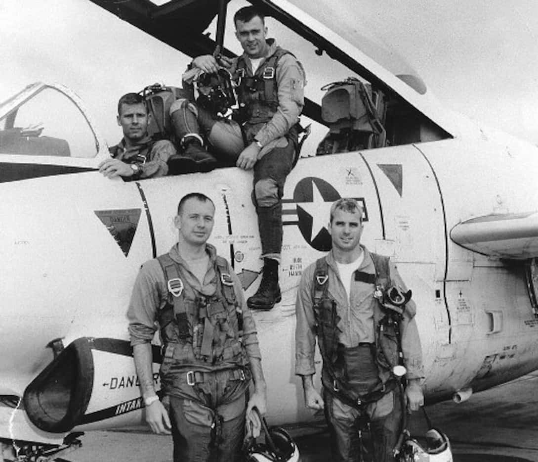 John McCain (right) posed with his squadron in a photo from 1965. 