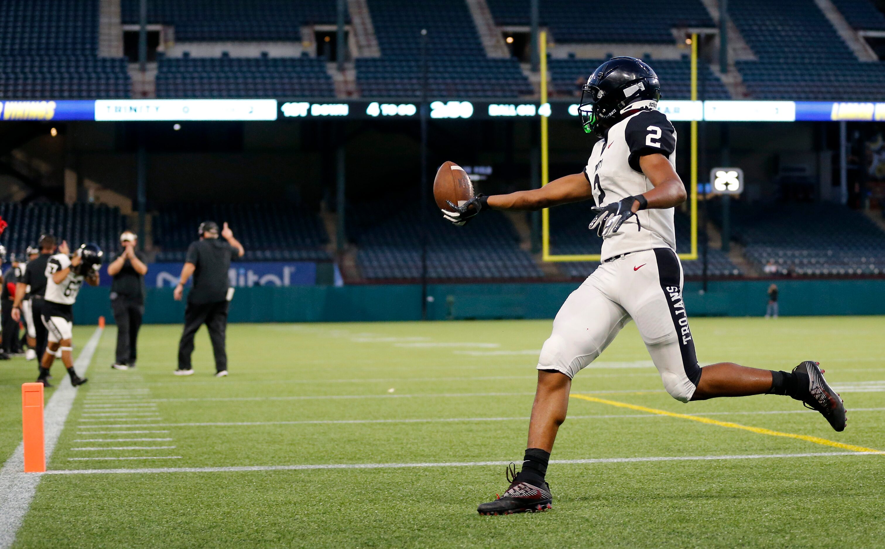 Euless Trinity running back Ollie Gordon (2) tosses the ball after scoring a first quarter...