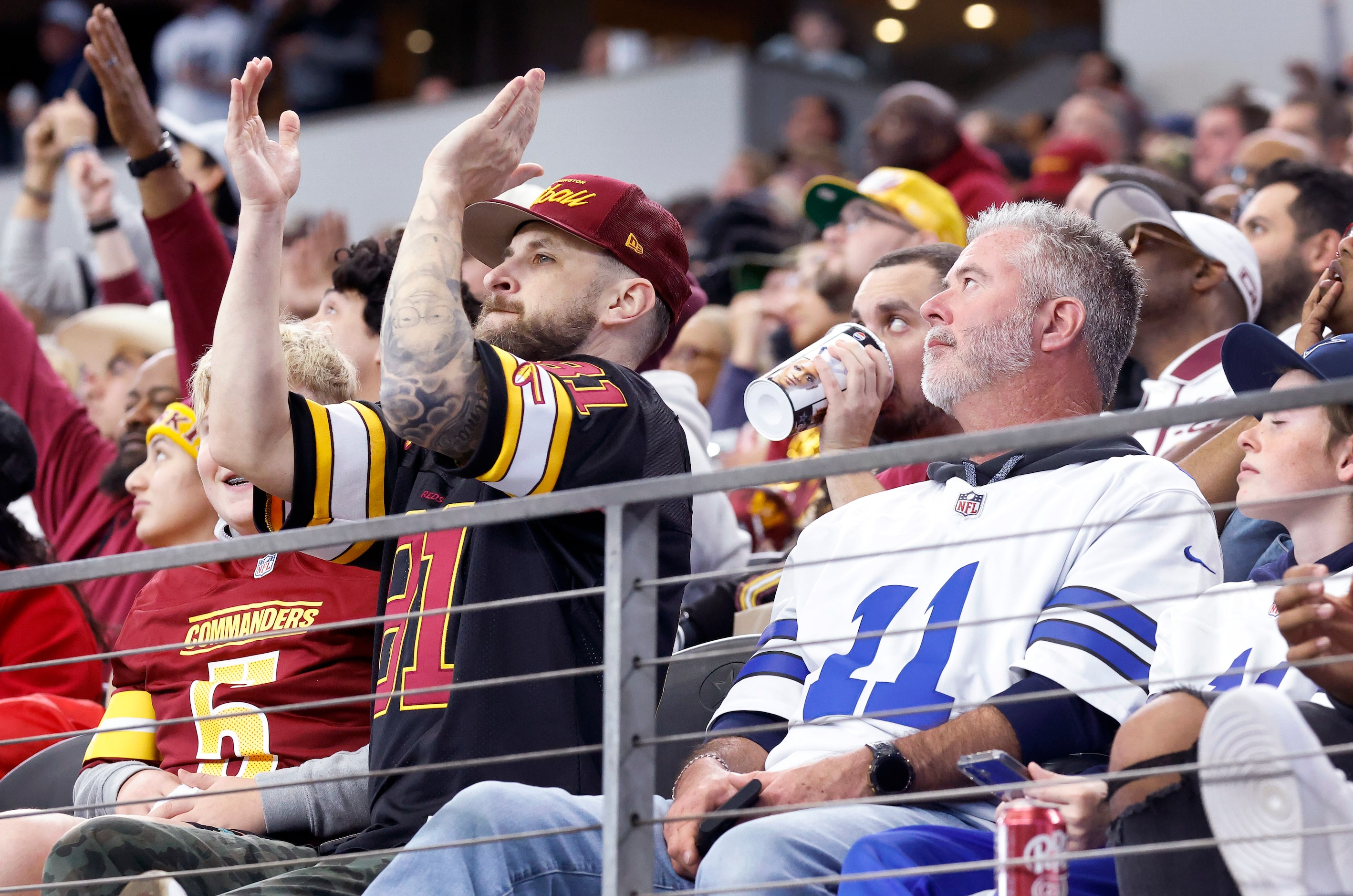 A Washington Commanders fan applauds after officials ruled on replay that Dallas Cowboys...