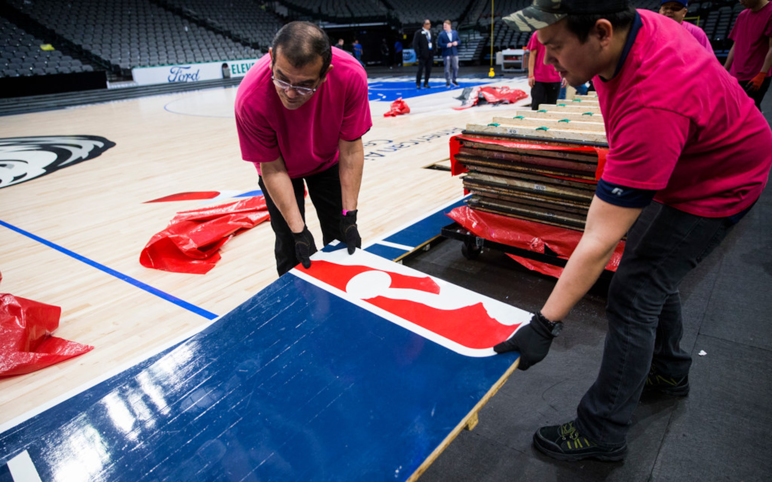 Crews break down the court after the Dallas Mavericks beat the Denver Nuggets 113-97 on...