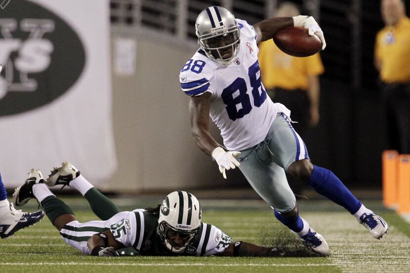 Dallas Cowboys wide receiver Dez Bryant (88) is driven out of bounds by New York Jets Isiah...