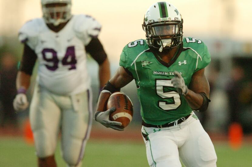 University of North Texas junior running back Lance Dunbar (5) lets loose down the middle...