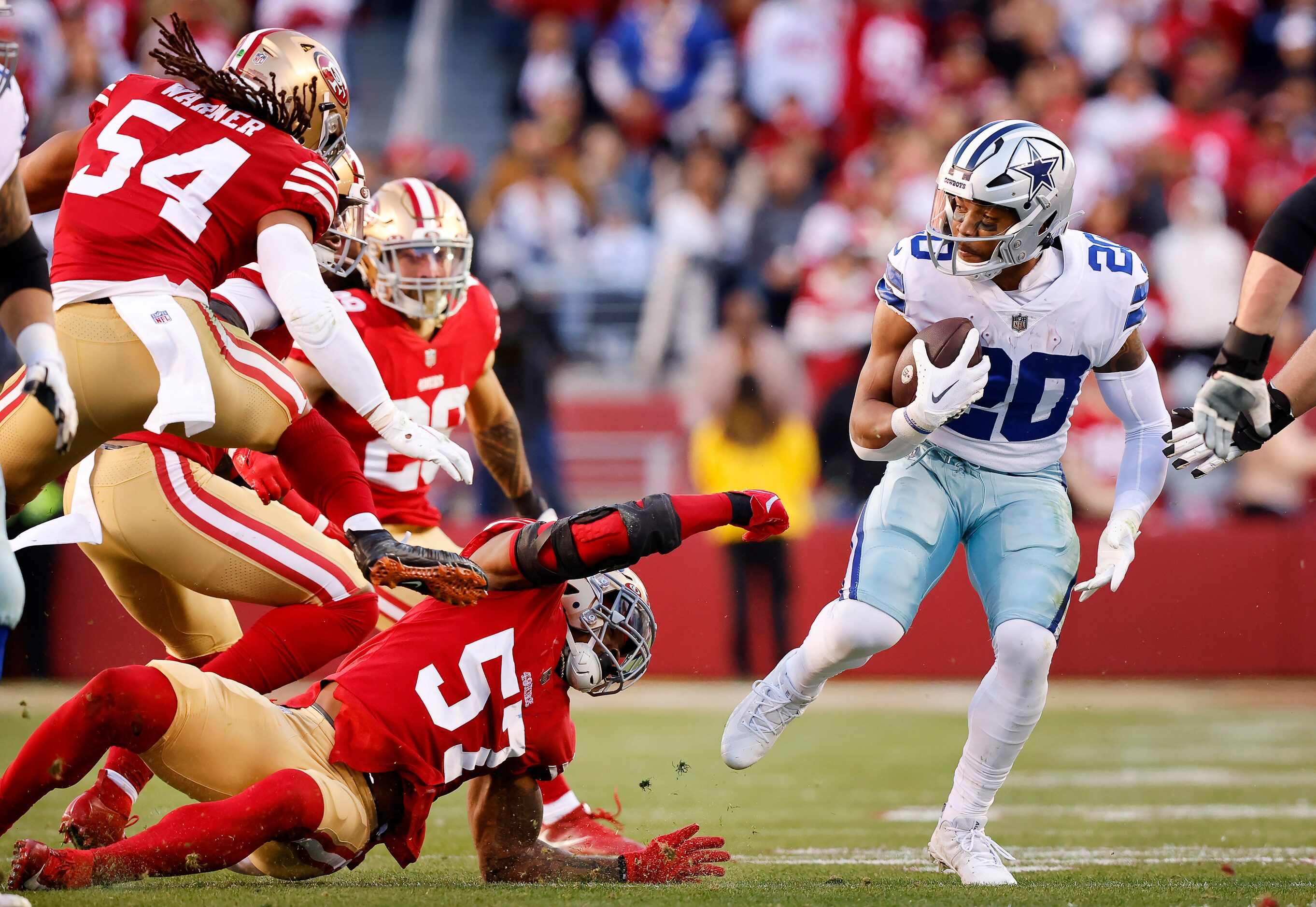 Dallas Cowboys running back Tony Pollard (20) is spin around by San Francisco 49ers...