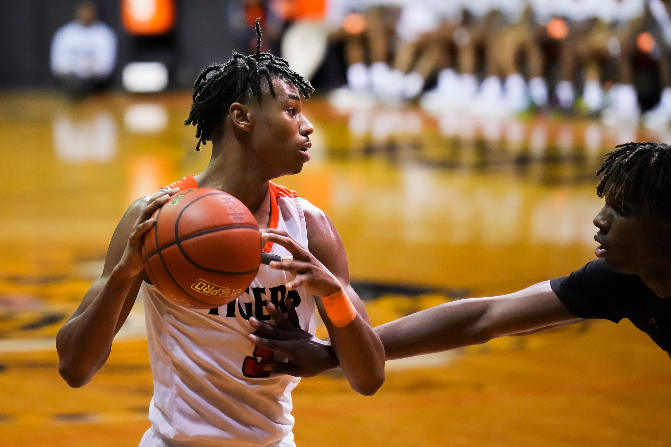 Lancaster's Joseph Mayberry III (3) is defended by Forney forward Ronnie Harrison (0) during...