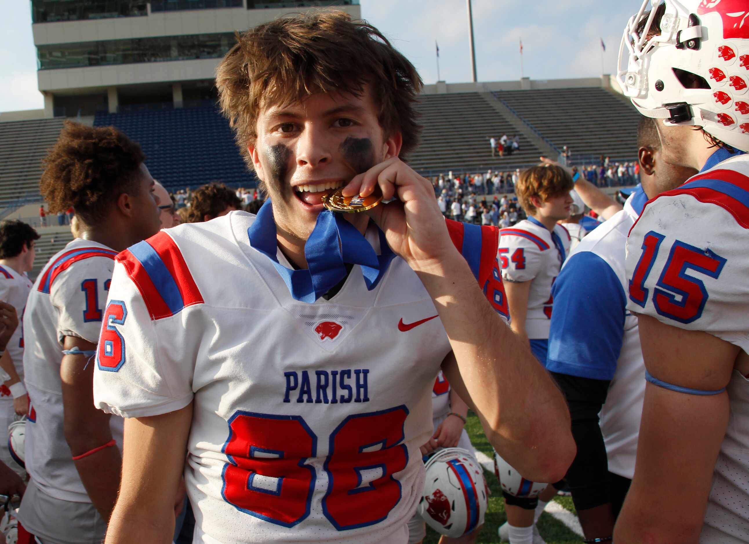 Parish Episcopal's Mercer Mcdougal (86) bites down on his championship medal which was...