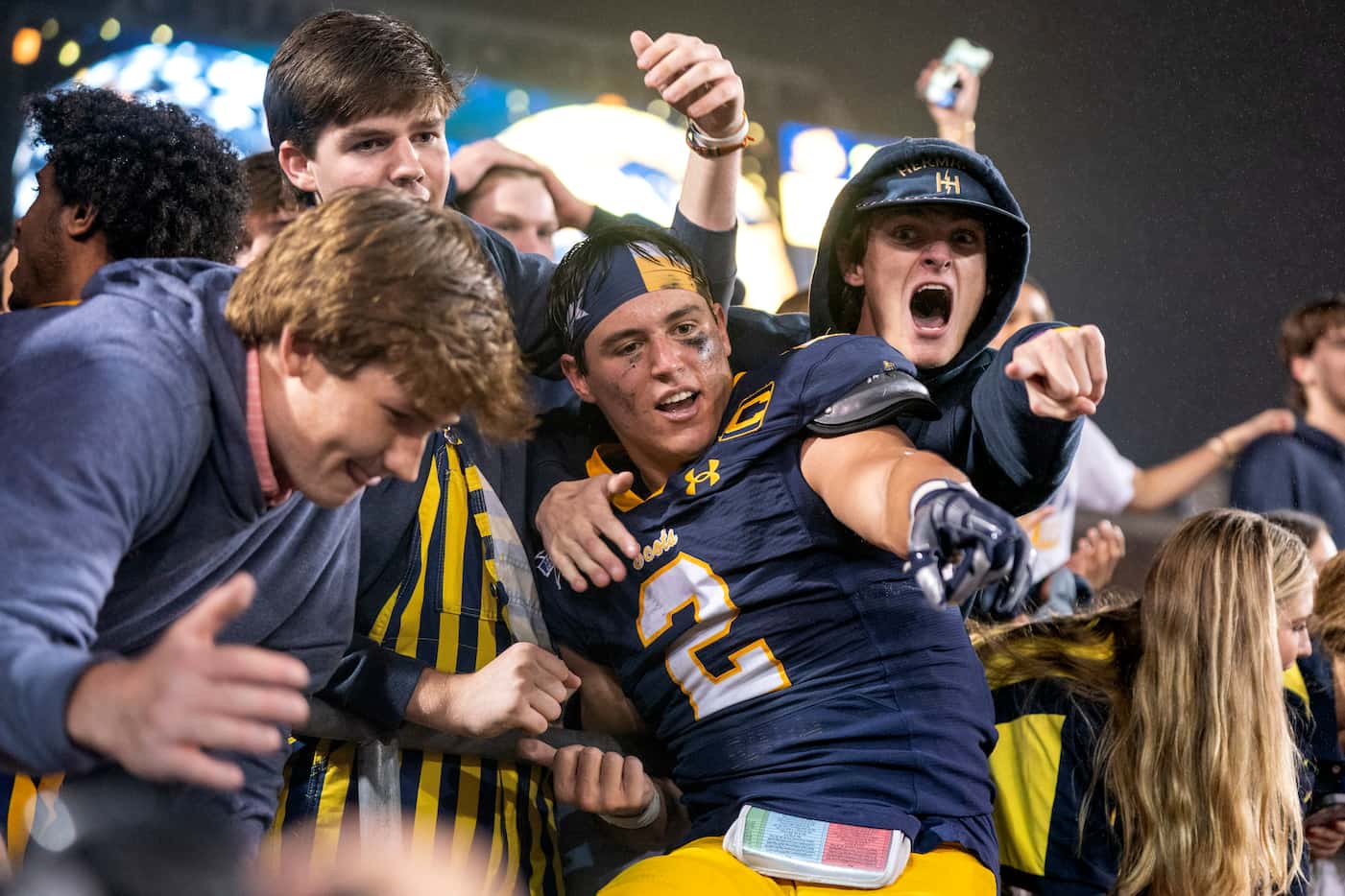 Highland Park senior running back Wilson Axley (2) celebrates in the student section after...