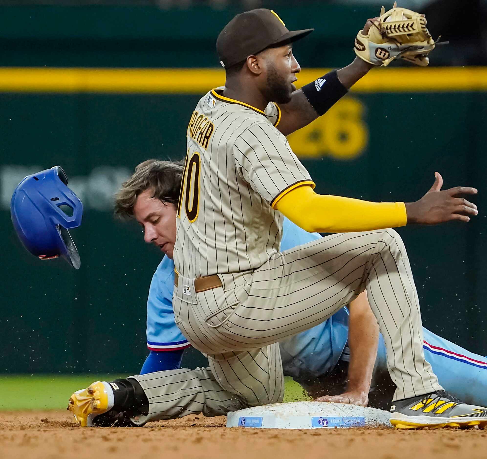 Texas Rangers outfielder Eli White is caught stealing as San Diego Padres second baseman...