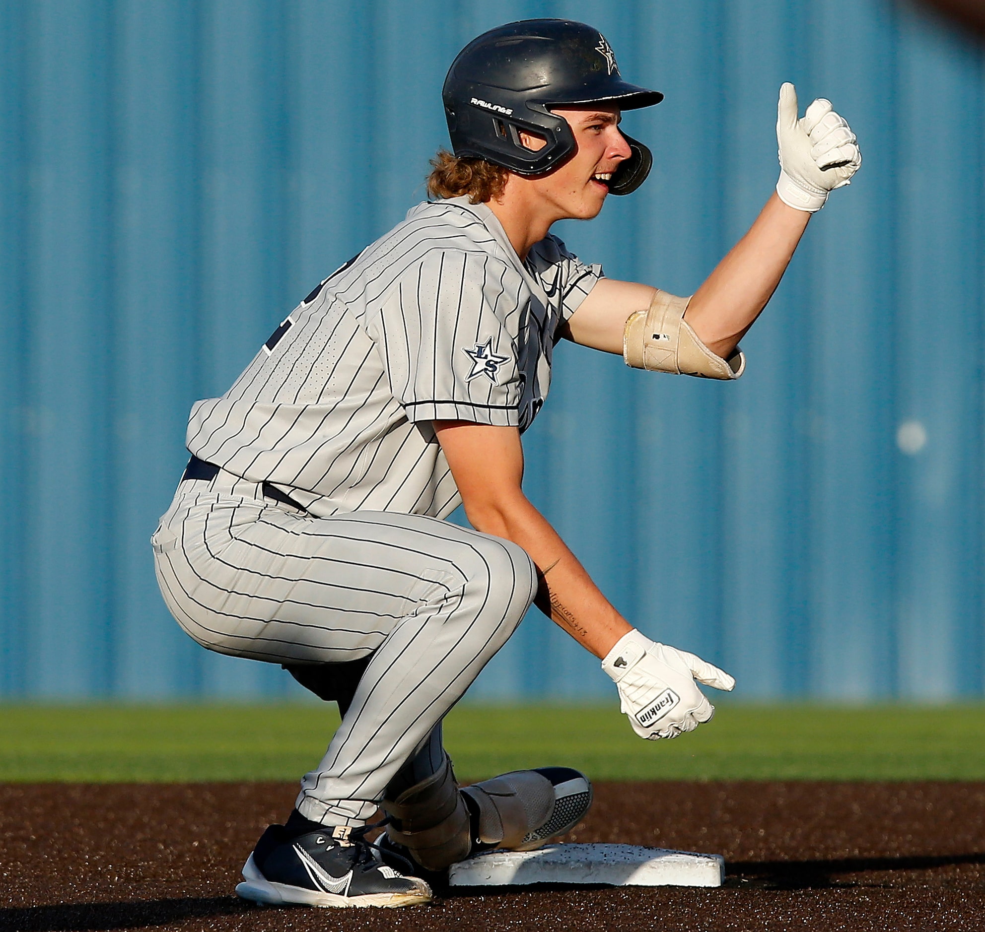 Lone Star High School pitcher Dom Reid (22) celebrates a two RBI double in the first inning...