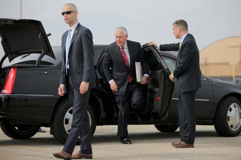 Secretary of State Rex Tillerson exits his limousine at Andrews Air Force Base, Md.,...