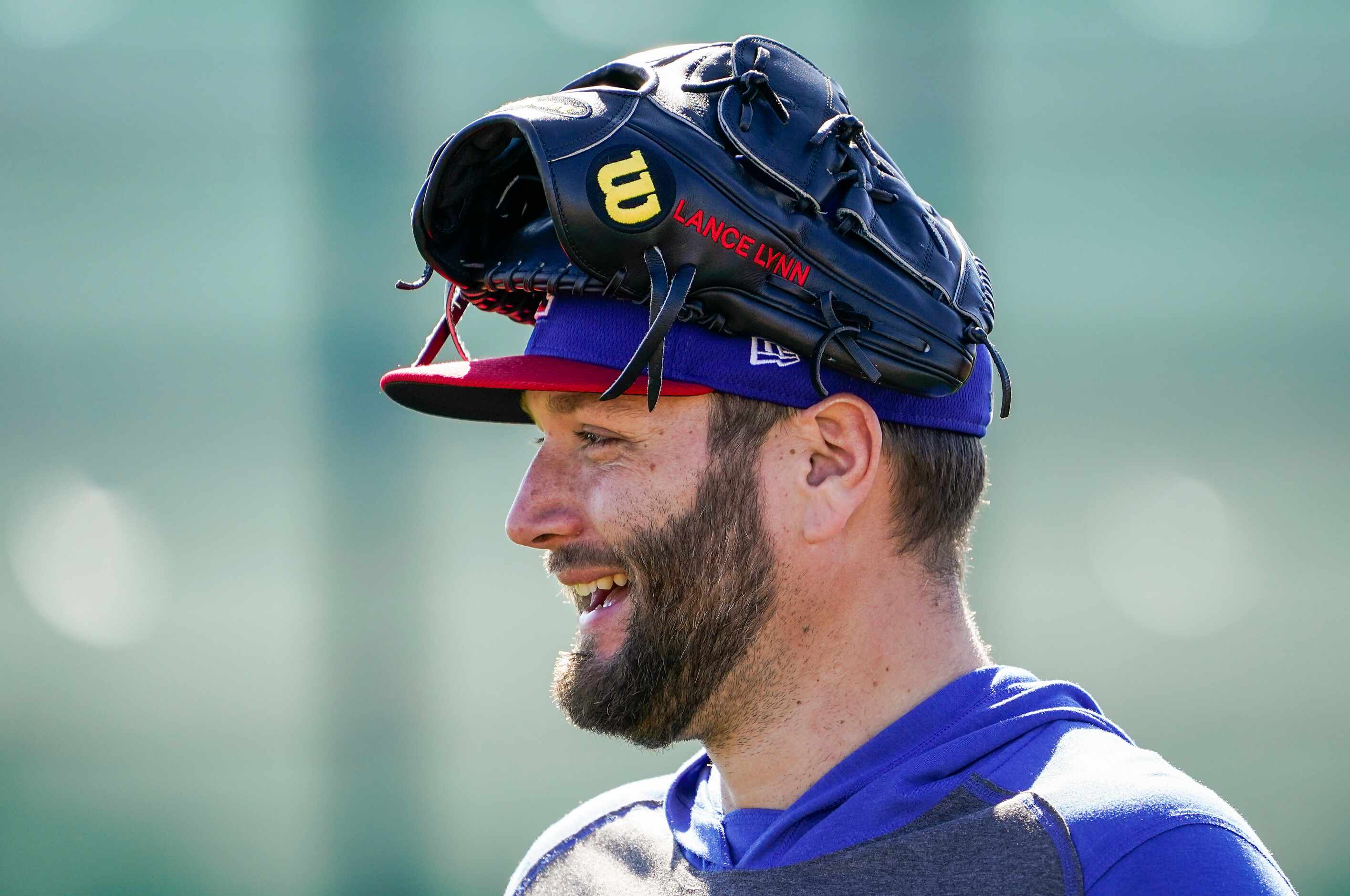Texas Rangers pitcher Lance Lynn laughs with teammates during a spring training workout at...