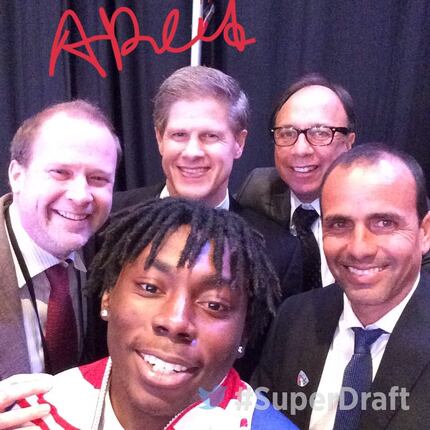 Adonijah Reid (front, center), with (left to right) FC Dallas owners Dan and Clark Hunt,...