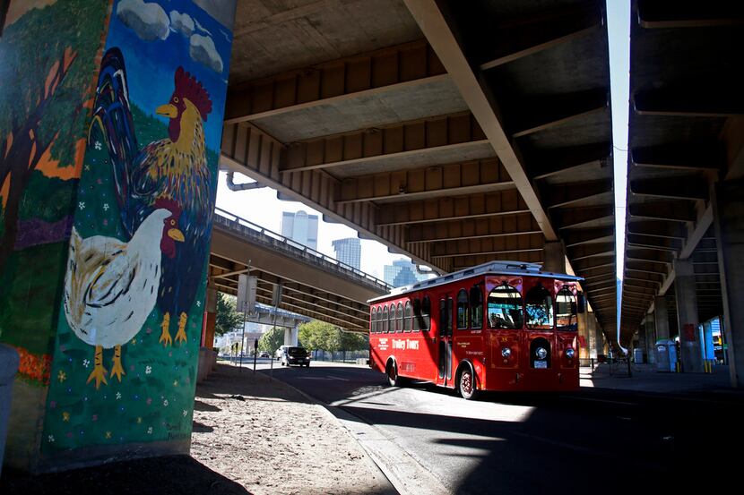 A Trolley Tours bus heads east on Commerce St. into Deep Ellum under I-345 in Dallas...