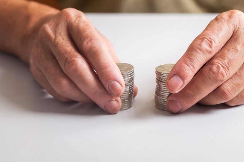 old man with coins in hand on table