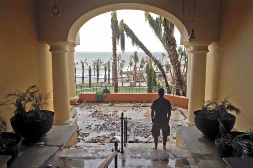 
A tourist looked out from the debris-filled Hilton hotel in Los Cabos, Mexico, after...