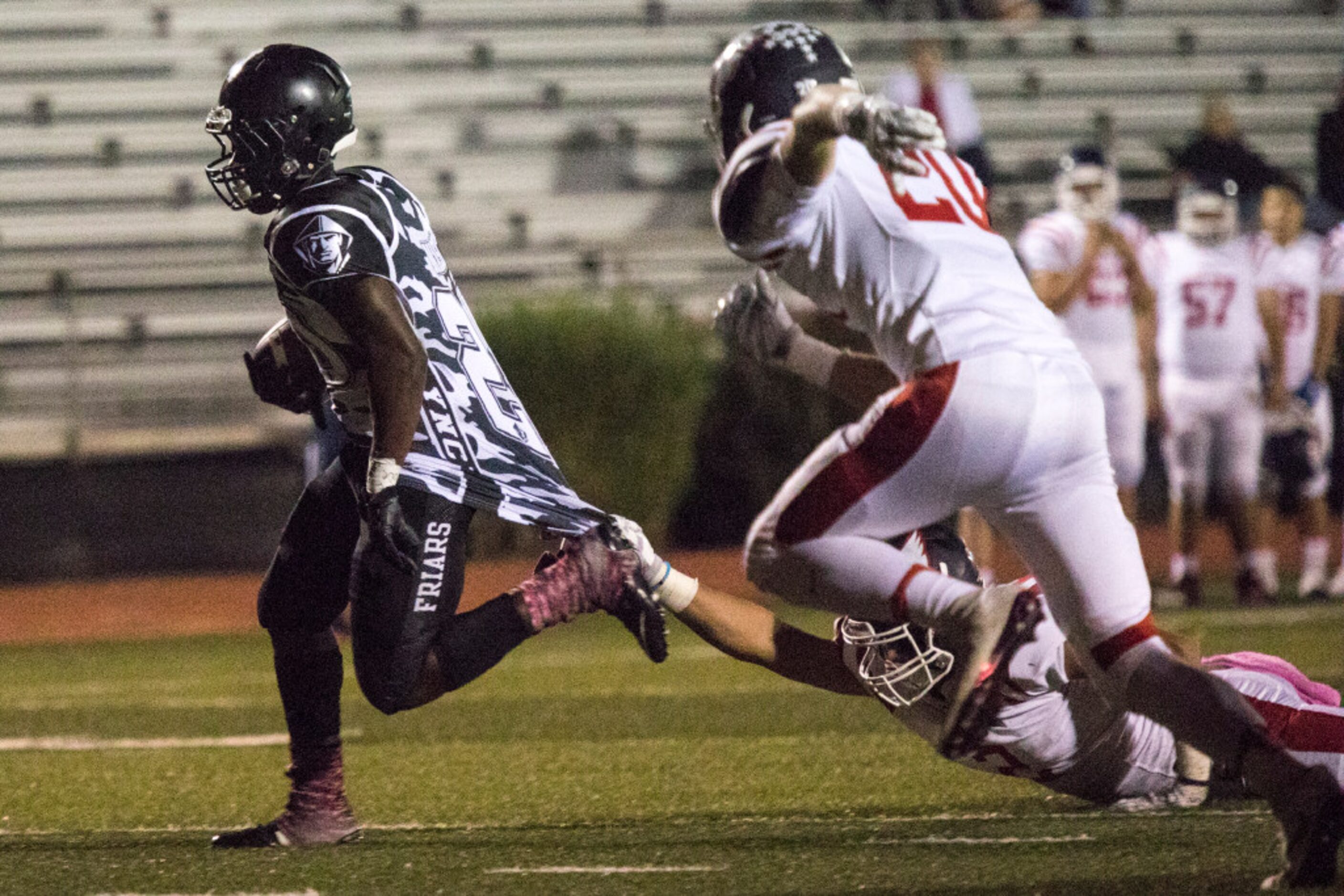 Bishop Lynch running back Jermaine Mask (20) pulls a Cardinals defender into the end zone...