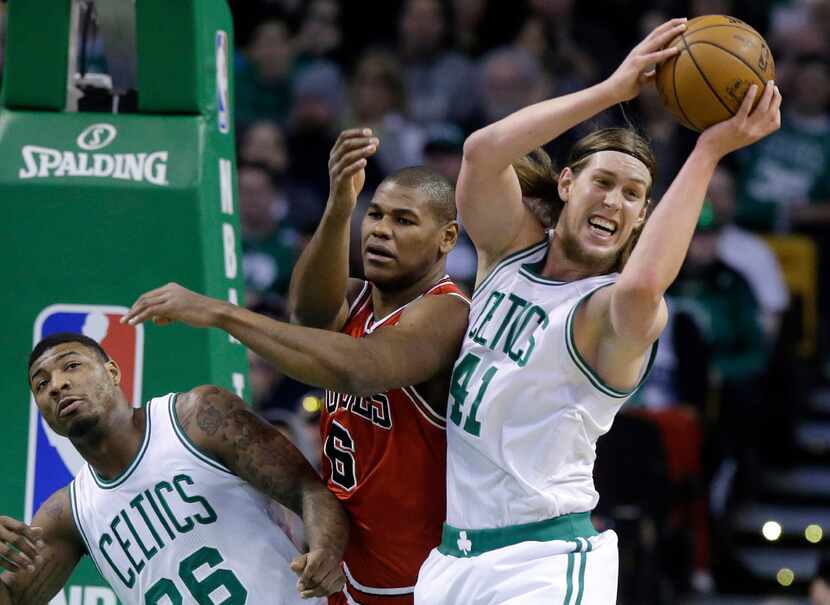Boston Celtics center Kelly Olynyk (41) grabs a rebound over the arms of Chicago Bulls...